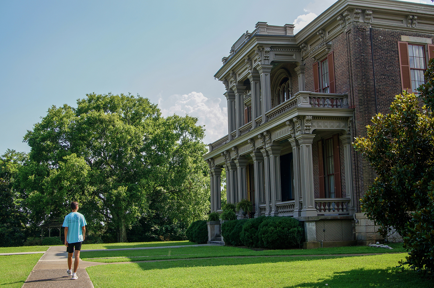 >Walking in front of Two Rivers Mansion